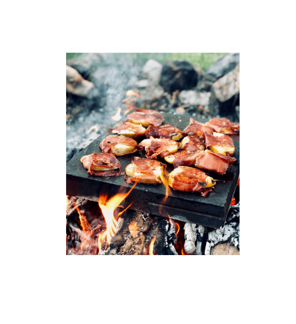 Morceaux de viande grillés sur une plaque au-dessus du feu
