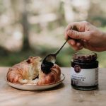 Confiture d'amélanches tartinée sur un croissant.