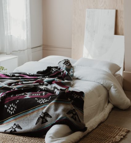 Couverture réversible Éclair – Éco étendue sur un lit dans une chambre