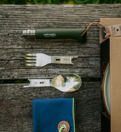 Ensemble de camping avec couteau, fourchette et cuillère sur planche en bois