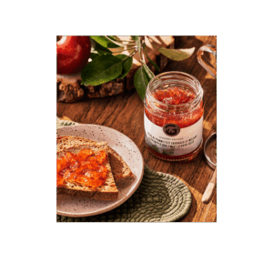 Jar of wild crabapple jelly with toast on a wooden table